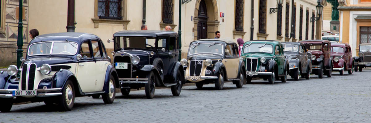 vintage cars lined up on the street for private vintage car tour